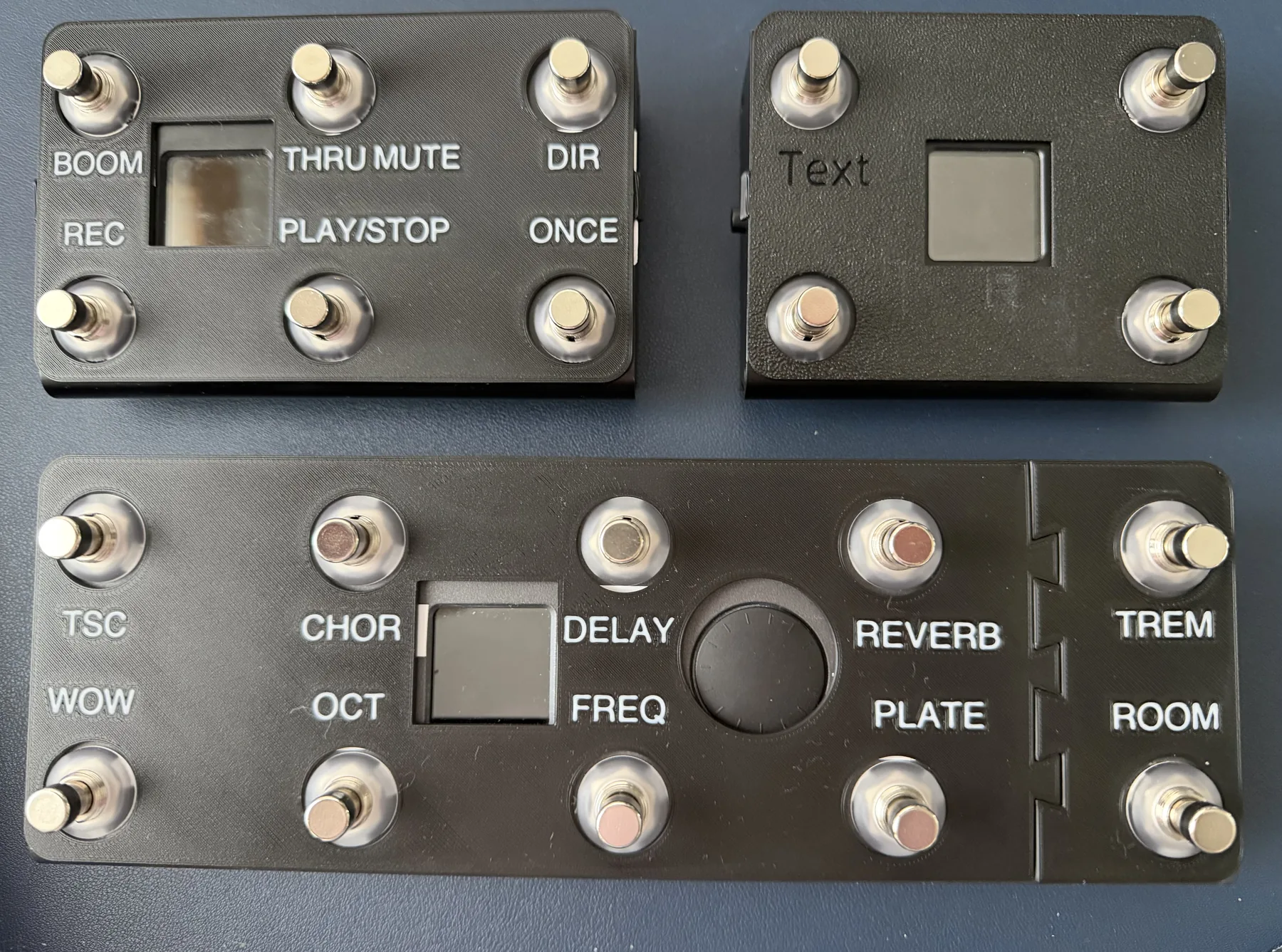 Three Paint Audio MIDI Captain pedals with black faceplates fitted. The Mini 6 reads BOOM, THRU MUTE, DIR, REC, PLAY/STOP, ONCE. The STD 10 reads TSC, CHOR, DELAY, REVERB, TREM, WOW, OCT, FREQ, PLATE, ROOM.